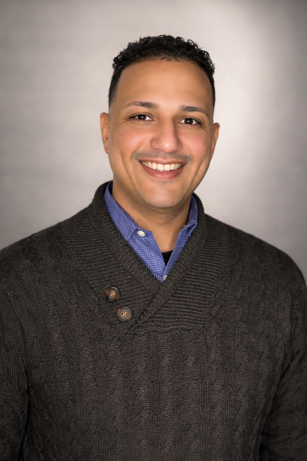 Professional headshot with warm smile